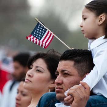 Latino family with American flag.
