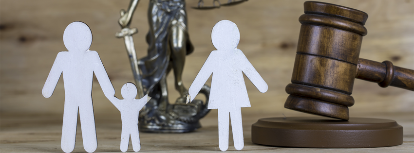 Gavel and a family separated from a child shown with paper figures
