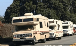 Cropped photo of RVs parked on a street in the city of Pacifica