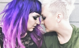 Sera and Frankie of band Unsung Lilly in pose where their foreheads are touching