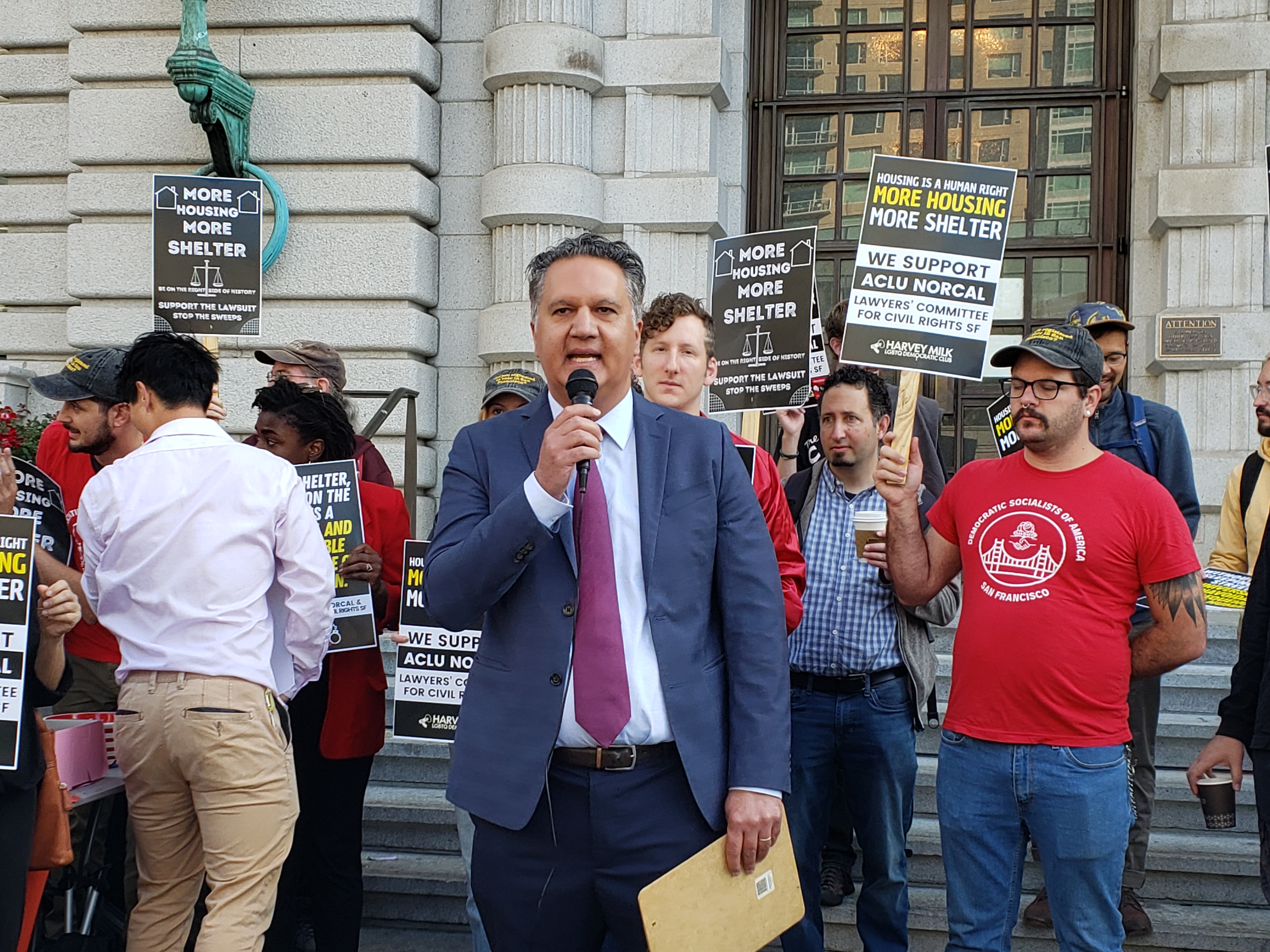 ACLU NorCal Executive Director Abdi Soltani speaks at a rally before a hearing at the Ninth Circuit Court of Appeals on the federal injunction barring San Francisco from citing and arresting unhoused people who have no access to shelter.