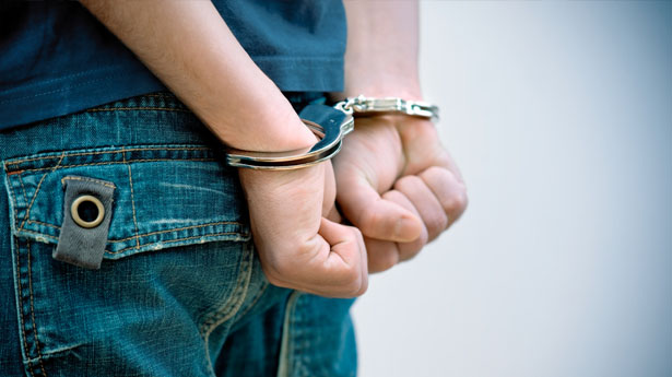 person in handcuffs via shutterstock