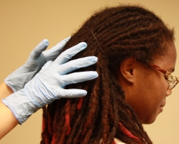 Staff attorney Novella Coleman having her hair searched.