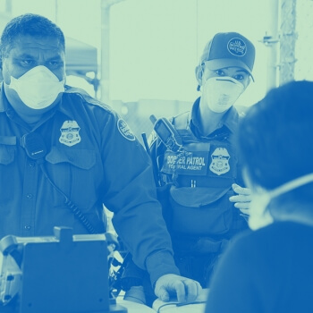 Customs and Border patrol officer questioning a person at a port of entry