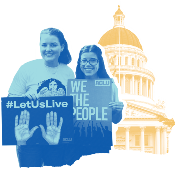 Two people holding signs in front of Sacramento State Capitol