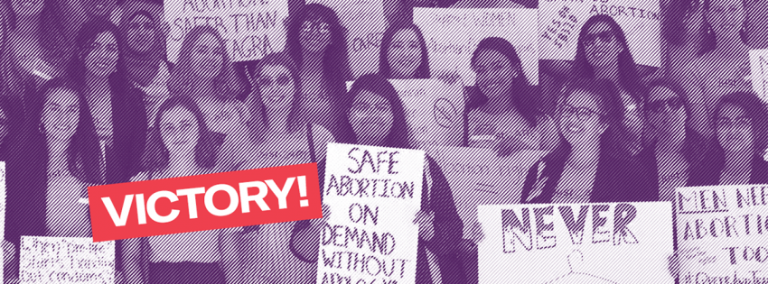 youth activists holding safe abortion signs