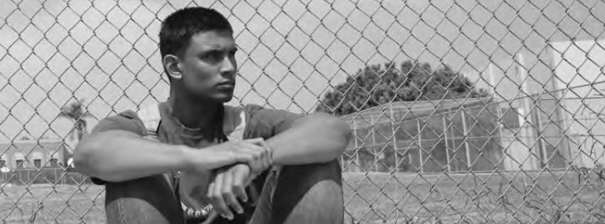 The right to remain a student, student sitting in front of a fence