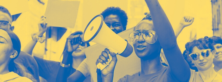 a woman with a raised fist and megaphone