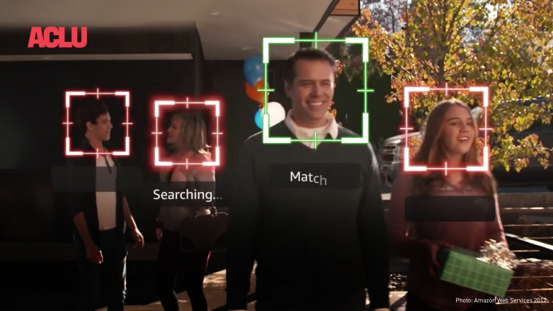 Four people walk down a pathway outside a building while Amazon tracks their faces