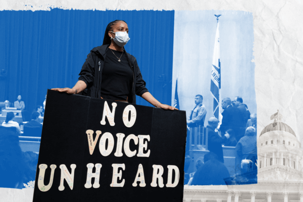 Activist holding poster that reads "No Voice Unheard"