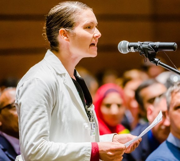 Woman speaking into a microphone