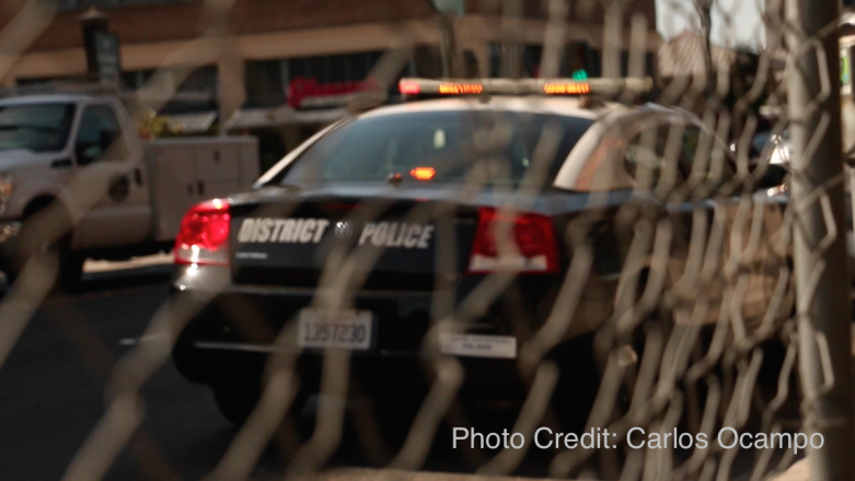 Police car with writing on the trunk that reads District Police