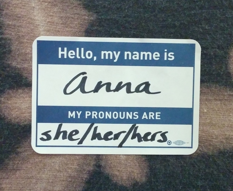 A name tag. It says: Hello, my name is Anna. My pronouns are she/her/hers