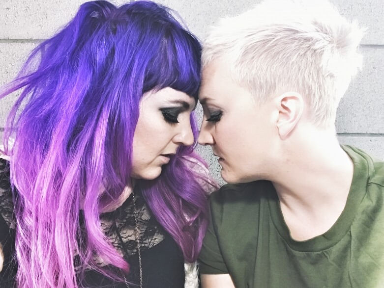 Sera and Frankie of band Unsung Lilly in pose where their foreheads are touching