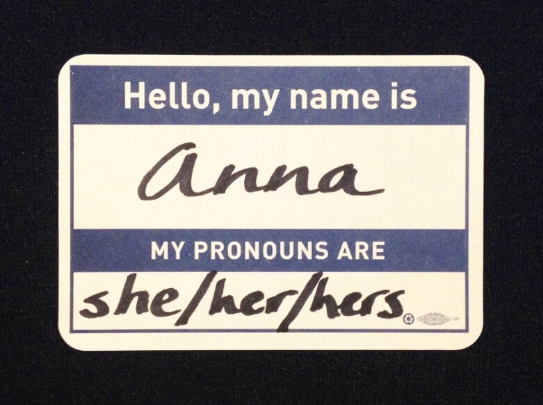 A name tag. It says: Hello, my name is Anna. My pronouns are she/her/hers