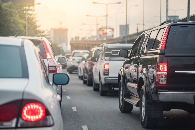 cars in a line of traffic on an urban road