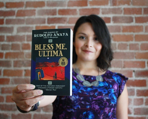 Daisy Vieyra holding a copy of Bless Me, Ultima