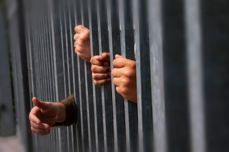 hands behind bars