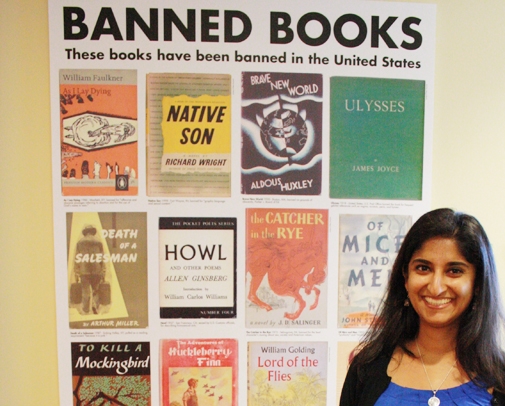 Laila Fahimuddin stands in front of an ACLU poster featuring banned books such as Howl and Native Son