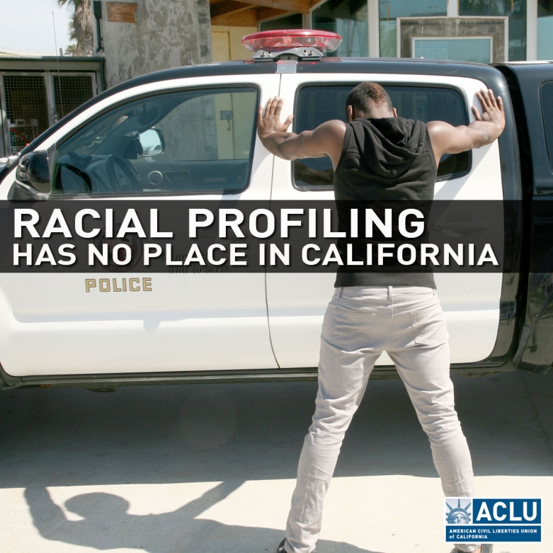 African American man with his hands on a police vehicle.