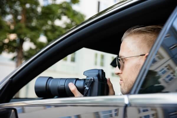 stock photo of a man in a car with a camera