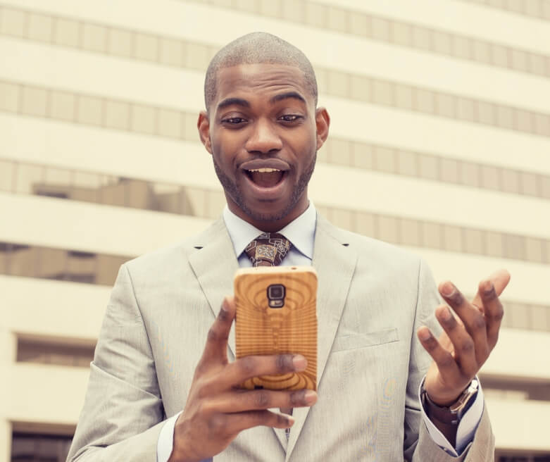 man looking into his smart phone - shutterstock