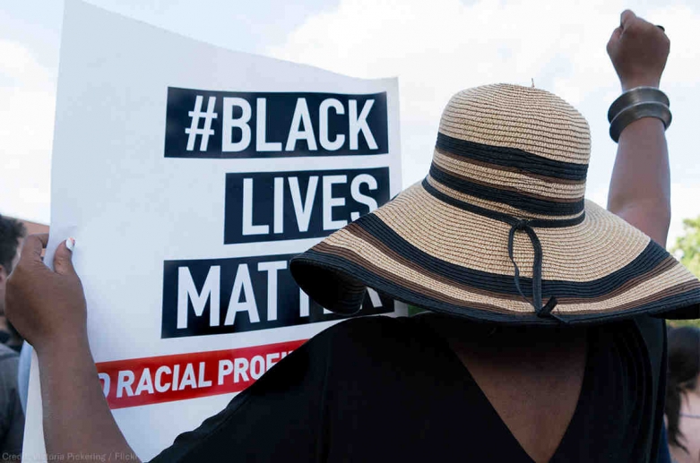 Woman holding black lives matter sign.