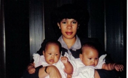 photo of a mother holding two babies