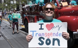 Women with a sign "I love my transgender son"