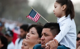 Latino family with American flag.