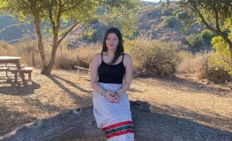 student sitting outside on a tree