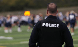 Police officer looking at students