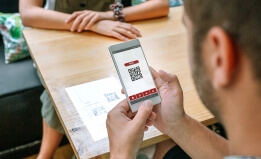 Customer scanning QR code at restaurant