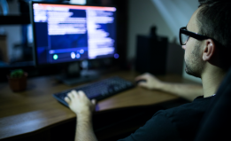 person looking at computer - shutterstock