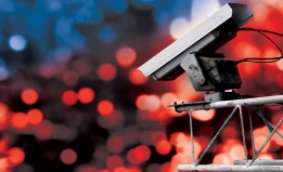 Surveillance camera high above blurred city lights