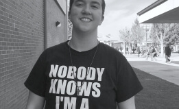 ACLU client Taylor Victor wearing t-shirt at school that reads "Nobody Knows I'm a Lesbian"