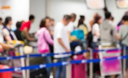 People waiting in line for security screening at an airport