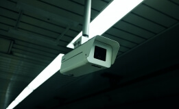 A photograph of a white surveillance camera