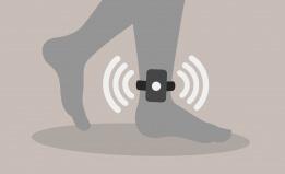 Illustration of an ankle monitor strapped to a person's leg. 
