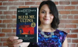 Daisy Vieyra holding a copy of Bless Me, Ultima