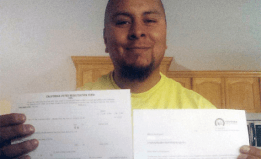 Marco Rodriguez receives his voter registration card from Covered California. 
