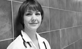 doctor leaning against wall