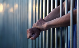 hands behind bars