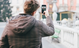 person taking a photo with his mobile phone