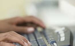 hands typing on a keyboard