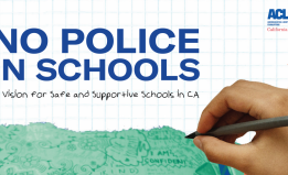 a hand holding a pen on the right and text that reads 'No Police In Schools'