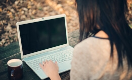 person at a laptop via Shutterstock