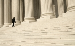 A man ascending the steps at the entrance to the US Supreme Court in Washington, DC.