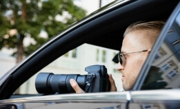 stock photo of a man in a car with a camera