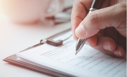 hand filling out a form